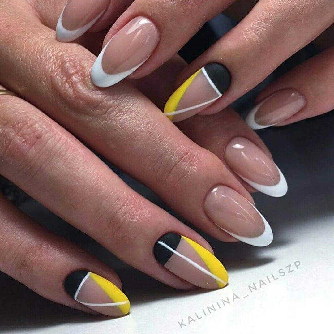 diseño de uñas amarillas con blanco y negro